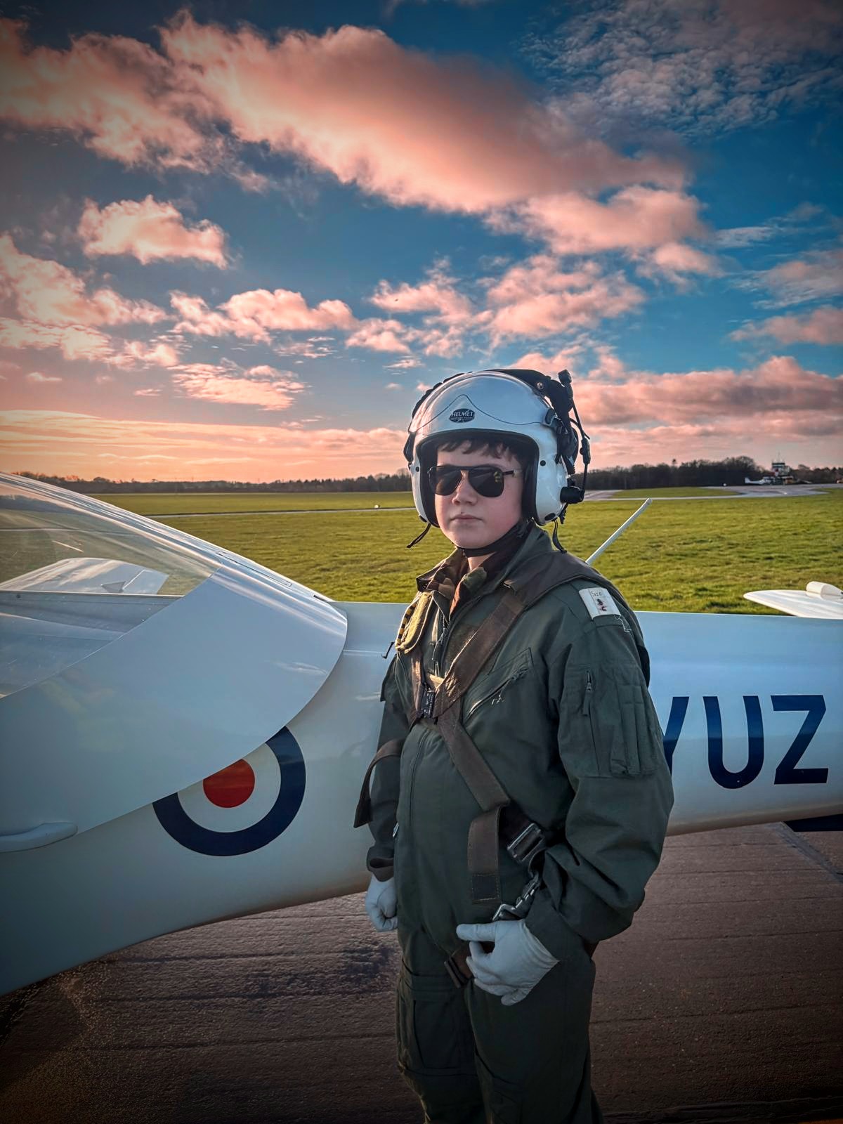 Mason Hughes standing beside an aircraft