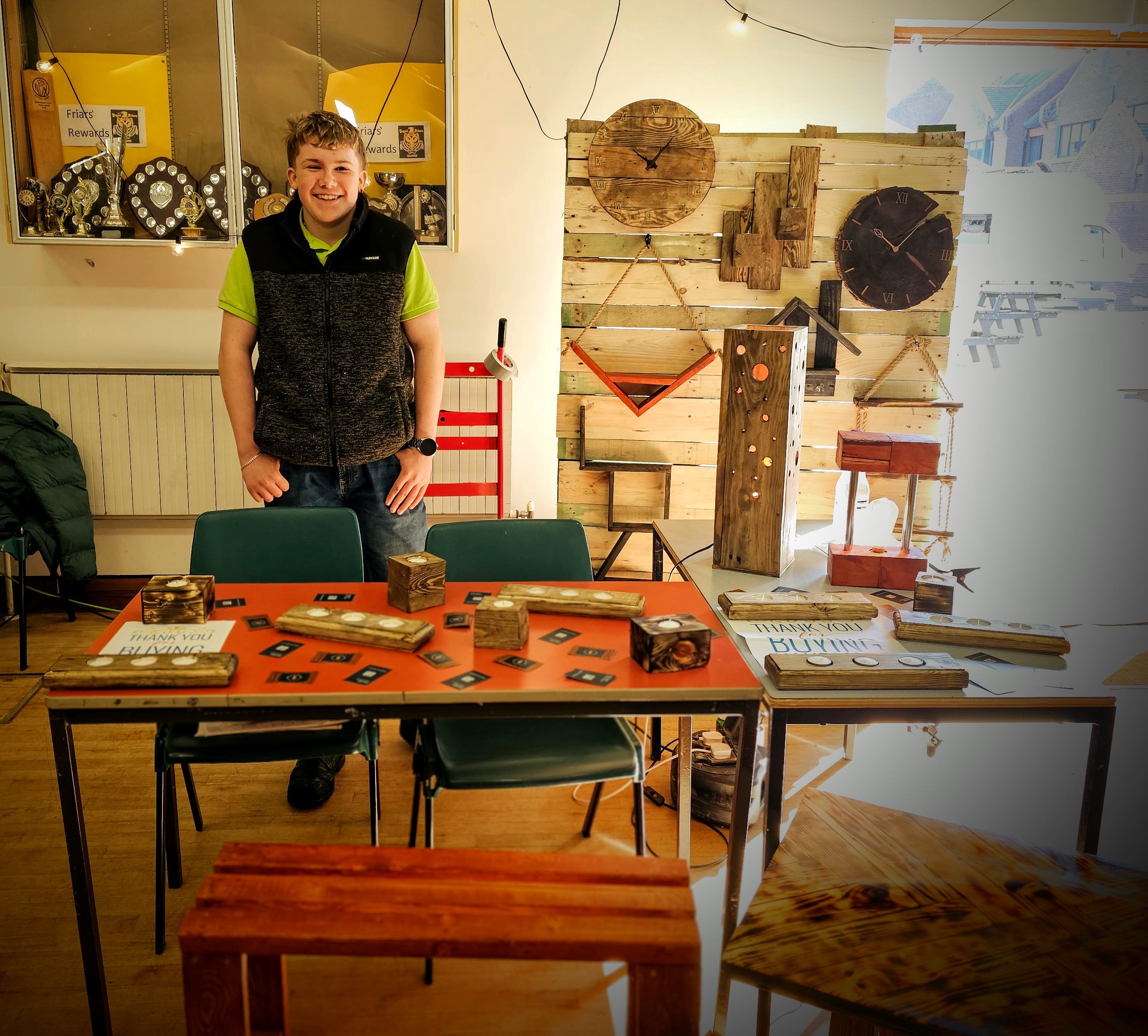 Mason Hughes with his handcrafted woodworking display